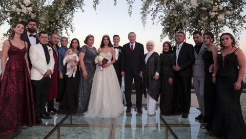 Turkey's President Recep Tayyip Erdogan, center right, Turkish-German soccer player Mesut Ozil, centre, his wife Amine Gulse, center left, Erdogan's wife Emine Erdogan pose for a photo with family members of newly wed couple during a wedding ceremony over the Bosporus in Istanbul, Friday, June 7, 2019.(Presidential Press Service via AP, Pool)