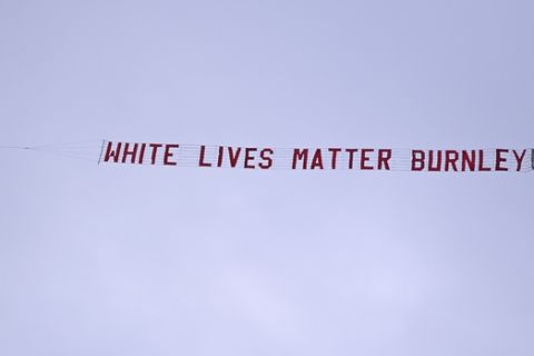 A plane towing a banner reading White Lives Matter Burnley flies above the stadium during the during the English Premier League soccer match between Manchester City and Burnley at Etihad Stadium, in Manchester, England, Monday, June 22, 2020. (AP Photo/Shaun Botterill,Pool)