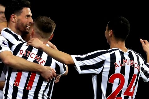 Newcastle United's Fabian Schar, left, celebrates scoring his side's first goal of the game with team mates , during the English Premier League soccer match between Newcastle and Burnley, at St James' Park, in Newcastle, England, Tuesday, Feb. 26, 2019. (Owen Humphreys/PA via AP)