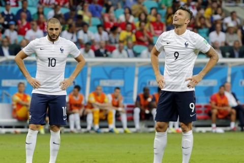 France's Karim Benzema, left, and Olivier Giroud stand together during the group E World Cup soccer match between Switzerland and France at the Arena Fonte Nova in Salvador, Brazil, Friday, June 20, 2014. (AP Photo/David Vincent)