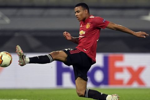 Manchester United's Mason Greenwood tries to score during the Europa League quarter-final soccer match between Manchester United and Copenhagen at the Rhein Energie Stadium in Cologne, Germany, Monday, Aug. 10, 2020. (Sascha Steinbach/EPA via AP)