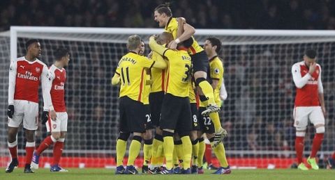 Watford's teammates celebrate after scoring during the English Premier League soccer match between Arsenal and Watford at the Emirates stadium in London, Tuesday, Jan. 31, 2017.(AP Photo/Frank Augstein)