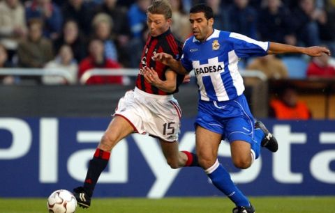 AC Milan'sJon Tomasson, left fights for the ball with Deportivo La Coruna's Nourredine Naybet  during their Champions League quarter-finals second leg match Wednesday, April 7 2004, in La Coruna, northern Spain. In the first leg Milan beat Deportivo 4-1. (AP Photo/Lalo Villar)