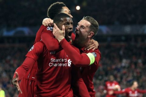 Liverpool's Georginio Wijnaldum, center, celebrates scoring his side's third goal of the game during the Champions League Semi Final, second leg soccer match between Liverpool and Barcelona at Anfield, Liverpool, England, Tuesday, May 7, 2019. (Peter Byrne/PA via AP)