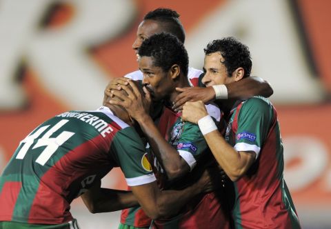 Maritimo's Heldon, center, from Cape Verde, celebrates with his teammates after scoring their second goal against Brugge during their Europa League group D soccer match in Funchal, Portugal,  Thursday, Dec. 6, 2012. (AP Photo/Helder Santos)