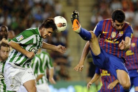 Barcelona's midfielder Sergio Busquets (R) vies with Real Betis' defender Javier Chica (L) during the Spanish League football match on May 12, 2012 at Benito Villamarin stadium in Sevilla.   AFP PHOTO/ CRISTINA QUICLER        (Photo credit should read CRISTINA QUICLER/AFP/GettyImages)