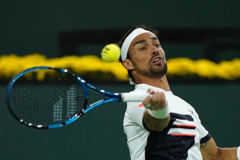 Fabio Fognini, of Italy, returns a shot to Stefanos Tsitsipas, of Greece, at the BNP Paribas Open tennis tournament Tuesday, Oct. 12, 2021, in Indian Wells, Calif. (AP Photo/Mark J. Terrill)