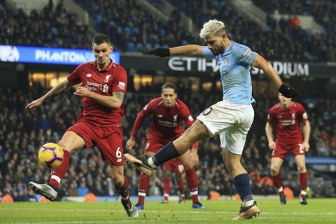 Manchester City's Sergio Aguero, right, shoots and scores the opening goal of the game during their English Premier League soccer match between Manchester City and Liverpool at the Ethiad stadium, Manchester England, Thursday, Jan. 3, 2019. (AP Photo/Jon Super)