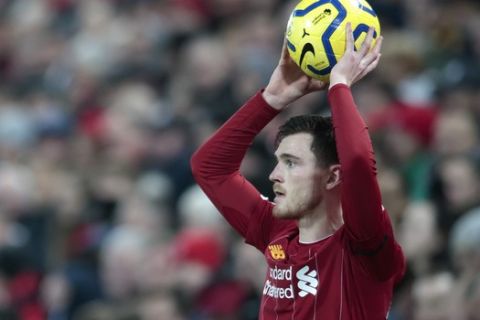 Liverpool's Andrew Robertson takes a throw in during the English Premier League soccer match between Liverpool and Brighton at Anfield Stadium, Liverpool, England, Saturday, Nov. 30, 2019. (AP Photo/Jon Super)