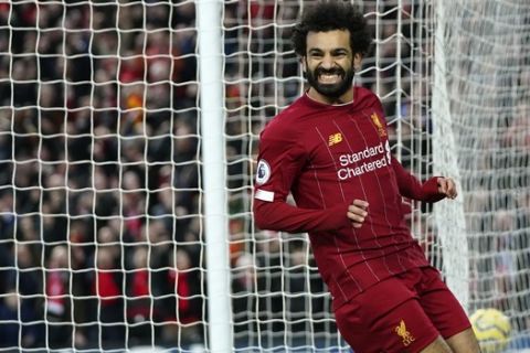 Liverpool's Mohamed Salah celebrates after scoring his sides third goal during the English Premier League soccer match between Liverpool and Southampton at Anfield Stadium, Liverpool, England, Saturday, February 1, 2020. (AP Photo/Jon Super)