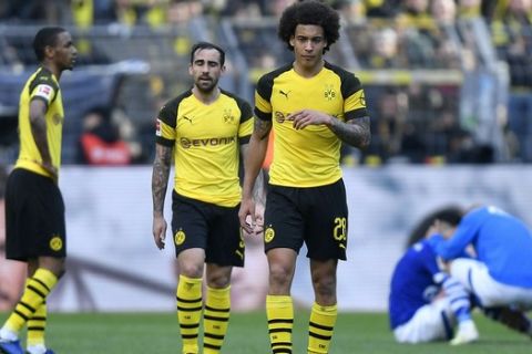 Dortmund's Axel Witsel and Dortmund's Paco Alcacer leave the pitch disappointed after losing the German Bundesliga soccer match between Borussia Dortmund and FC Schalke 04 in Dortmund, Germany, Saturday, April 27, 2019. Dortmund was defeated in the Derby by Schalke with 2-4. (AP Photo/Martin Meissner)