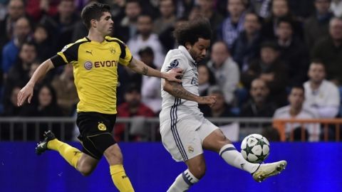 Dortmund's US midfielder Christian Pulisic (L) vies with Real Madrid's Brazilian defender Marcelo during the UEFA Champions League football match Real Madrid CF vs Borussia Dortmund at the Santiago Bernabeu stadium in Madrid on December 7, 2016. / AFP / JAVIER SORIANO        (Photo credit should read JAVIER SORIANO/AFP/Getty Images)