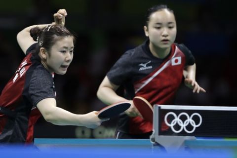 Japan's Mima Ito, right, and Ai Fukuhara play against Singapore's Yu Mengyu and Singapore's Zhou Yihan in the women's team bronze medal team table tennis match at the 2016 Summer Olympics in Rio de Janeiro, Brazil, Tuesday, Aug. 16, 2016. (AP Photo/Petros Giannakouris)