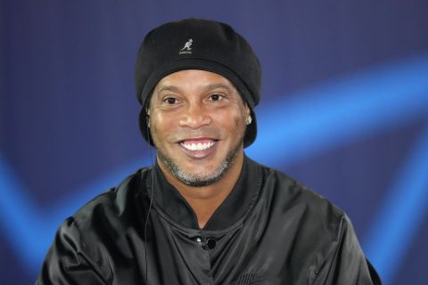 Former Brazil and PSG soccer legend Ronaldinho smiles as he answers a reporters question before the Champions League group A soccer match between Paris Saint Germain and RB Leipzig at the Parc des Princes stadium in Paris, Tuesday, Oct. 19, 2021. Ronaldinho is scheduled to do a lap of honor before that match starts. (AP Photo/Francois Mori)