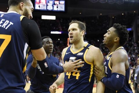 Utah Jazz forward Bojan Bogdanovic, center, celebrates after shooting the game-winning three point basket with Rudy Gobert, left, and Donovan Mitchell, right during the second half of an NBA basketball game against the Houston Rockets, Sunday, Feb. 9, 2020, in Houston. (AP Photo/Eric Christian Smith)