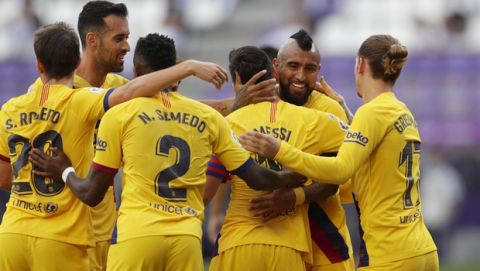 Barcelona's Arturo Vidal, second right, celebrates with teammates after scoring his side's first goal during the Spanish La Liga soccer match between Valladolid and FC Barcelona at the Jose Zorrilla stadium in Valladolid, Spain, Saturday, July 11, 2020. (AP Photo/Manu Fernandez)