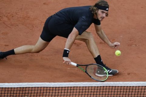 Greece's Stefanos Tsitsipas plays a shot against Spain's Jaume Munar in the first round match of the French Open tennis tournament at the Roland Garros stadium in Paris, France, Tuesday, Sept. 29, 2020. (AP Photo/Christophe Ena)