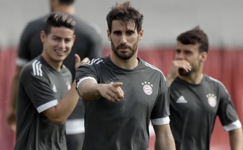 Bayern's Javi Martinez, front, gestures as he arrives for a training session at the Allianz Arena stadium in Munich, Germany, Tuesday, April 24, 2018. FC Bayern Munich will face Real Madrid for a Champions League semi final first leg soccer match in Munich on Wednesday, April 25, 2018. (AP Photo/Matthias Schrader)