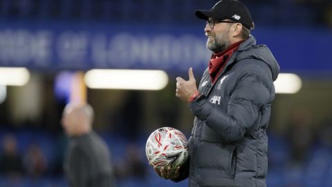 Liverpool's manager Jurgen Klopp reacts as he watches this players warm-up ahead of the English FA Cup fifth round soccer match between Chelsea and Liverpool at Stamford Bridge stadium in London Wednesday, March 4, 2020. (AP Photo/Kirsty Wigglesworth)