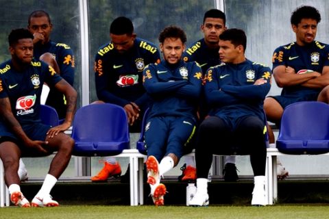 Brazil's Neymar sits next to captain Thiago Silva, right, and Fred, left, during the training session at Enfield Training Ground, in London, Tuesday June 5, 2018.   (John Walton/PA via AP)