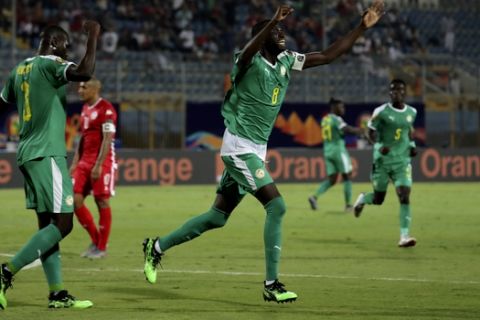 Senegal's Cheikhou Kouyate, left, celebrates after he scored during the African Cup of Nations semifinal soccer match between Senegal and Tunisia in 30 June stadium in Cairo, Egypt, Sunday, July 14, 2019. (AP Photo/Hassan Ammar)