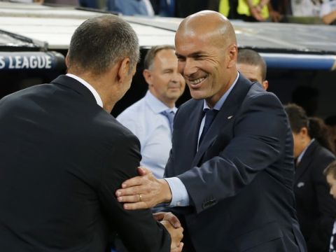 Real Madrid coach Zinedine Zidane, right, shakes hands with APOEL Nicosia coach Giorgos Donis before the Champions League group H soccer match between Real Madrid and Apoel Nicosia at the Santiago Bernabeu stadium in Madrid, Spain, Wednesday, Sept. 13, 2017. (AP Photo/Paul White)