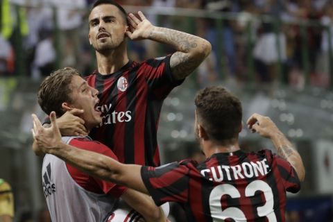 AC Milan's Suso celebrates after scoring with his teammate Patrick Cutrone during a Serie A soccer match between AC Milan and Cagliari, at the San Siro stadium in Milan, Italy, Sunday, Aug. 27, 2017. (AP Photo/Luca Bruno)