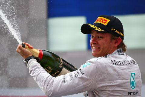 HOCKENHEIM, GERMANY - JULY 20:  Nico Rosberg of Germany and Mercedes GP celebrates on the podium after victory in the German Grand Prix at Hockenheimring on July 20, 2014 in Hockenheim, Germany.  (Photo by Dan Istitene/Getty Images)