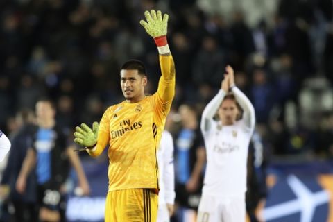 Real Madrid's goalkeeper Alphonse Areola, second left, jubilates with teammates after winning the Champions League group A soccer match between Brugge and Real Madrid at the Jan Breydel stadium in Bruges, Belgium, Wednesday, Dec. 11, 2019. (AP Photo/Francisco Seco)