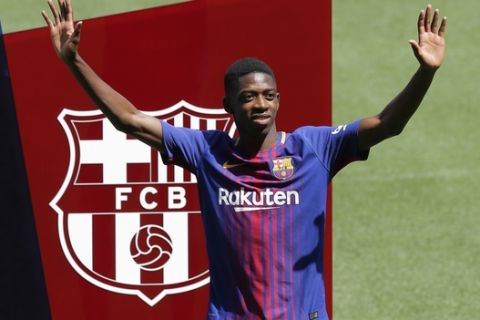 FILE  - In this Monday, Aug. 28, 2017 file photo, French soccer player Ousmane Dembele gestures during official presentation at the Camp Nou stadium in Barcelona, Spain. Dembele, the 20-year-old France striker signed by Barcelona to replace Neymar is expected to make his debut in the Catalan derby against Espanyol on Saturday, Sept. 9, 2017. (AP Photo/Manu Fernandez, File)