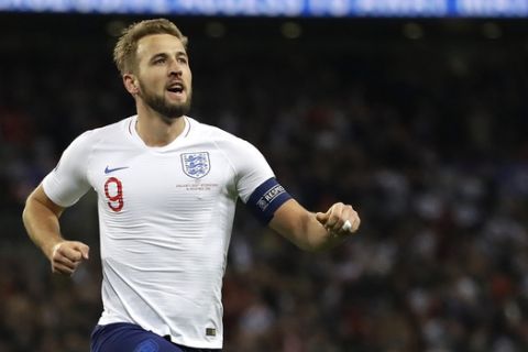 England's Harry Kane, right, celebrates scoring the fifth goal during the Euro 2020 group A qualifying soccer match between England and Montenegro at Wembley stadium in London, Thursday, Nov. 14, 2019. (AP Photo/Kirsty Wigglesworth)