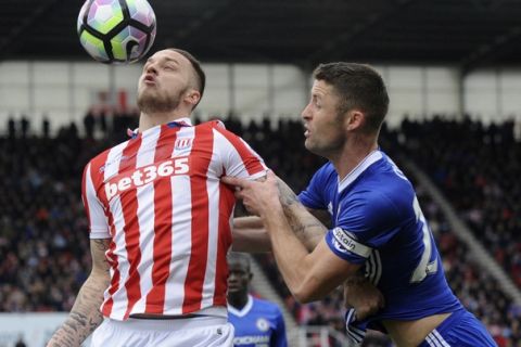Stoke's Marko Arnautovic, left, and Chelsea's Gary Cahill battle for the ball during the English Premier League soccer match between Stoke City and Chelsea at the Britannia Stadium, Stoke on Trent, England, Saturday, March 18, 2017. (AP Photo/Rui Vieira)