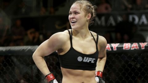 FILE - In this Feb. 22, 2014, file photo, Ronda Rousey looks around after defeating Sara McMann in a UFC 170 mixed martial arts women's bantamweight title bout in Las Vegas. Rousey says her bantamweight title shot against Amanda Nunes at UFC 207 will be one of her final mixed martial arts bouts. Rousey spoke about her fight Tuesday, Nov. 1, 2016, during an appearance on Ellen DeGeneres talk show. (AP Photo/Isaac Brekken, File)