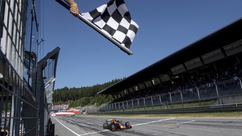 Red Bull driver Max Verstappen of the Netherlands crosses the finish line to win the Austrian Formula One Grand Prix at the Red Bull Ring racetrack in Spielberg, southern Austria, Sunday, June 30, 2019. (Christian Bruna, Pool via AP)