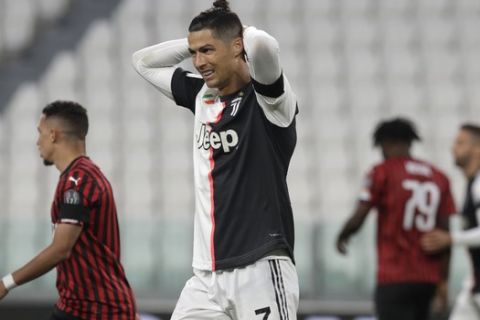 Juventus' Cristiano Ronaldo grimaces during an Italian Cup second leg soccer match between Juventus and AC Milan at the Allianz stadium, in Turin, Italy, Friday, June 12, 2020. The match was being played without spectators because of the coronavirus lockdown. (AP Photo/Luca Bruno)