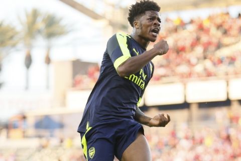 Arsenal's Chuba Akpom celebrates scoring a goal by jumping in the air against Chivas Guadalajara's during the second half of a friendly soccer match in Carson, Calif., Sunday, July 31, 2016. (AP Photo/Danny Moloshok)