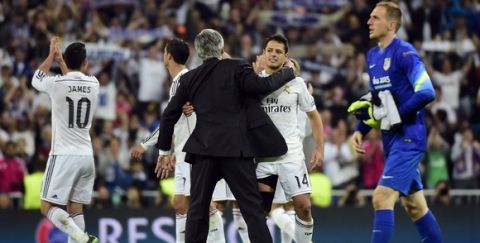 Real Madrid's Italian coach Carlo Ancelotti  (C L) congratulates his player Real Madrid's Mexican forward Javier Hernandez (C R) next to Atletico Madrid's Slovenian goalkeeper Jan Oblak (R) at the end of the UEFA Champions League quarter-finals second leg football match Real Madrid CF vs Club Atletico de Madrid at the Santiago Bernabeu stadium in Madrid on April 22, 2015. Real Madrid won 1-0.    AFP PHOTO / GERARD JULIEN        (Photo credit should read GERARD JULIEN/AFP/Getty Images)