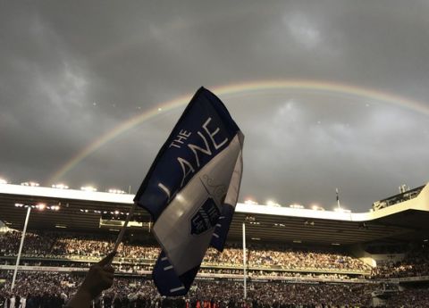 A rainbow appears as fans invade the pitch after the English Premier League soccer match between Tottenham Hotspur and Manchester United at White Hart Lane stadium in London, Sunday, May 14, 2017. It was the last Spurs match at the old stadium, a new stadium is being built on the site. (AP Photo/Frank Augstein)