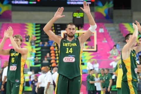 BARCELONA, SPAIN - SEPTEMBER 11: Jonas Valanciunas #14 of the Lithuania National Team waves to the crowd after the game against the USA Basketball Men's National Team during the 2014 FIBA World Cup Semi-Finals at Palau Sant Jordi on September 11, 2014 in Barcelona, Spain.  NOTE TO USER: User expressly acknowledges and agrees that, by downloading and/or using this Photograph, user is consenting to the terms and conditions of the Getty Images License Agreement. Mandatory Copyright Notice: Copyright 2014 NBAE (Photo by Jesse D. Garrabrant/NBAE via Getty Images)