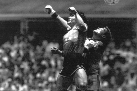 FILE - This is a Sunday, June 22, 1986 file photo of Argentina's Diego Maradona, left, as he is seen in the controversial action in which he knocked the ball with his left hand into the net of England's goalie Peter Shilton to score his team's first goal when Argentina defeated England 2-1 in the World Cup quarterfinal in the Mexico City Aztec stadium. Cheating. It's an ugly side of the beautiful game and it involves just about every aspect of it. The World Cup in Brazil begins in June and the founders of association football would shudder at how entrenched deception and trickery have become in the modern game. (AP Photo/El Grafico, File)