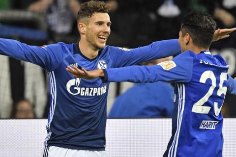 Schalke's Leon Goretzka celebrates with teammate Amine Harit, right, after he scored the opening goal during the German Bundesliga soccer match between FC Schalke 04 and FSV Mainz 05 at the Arena in Gelsenkirchen, Germany, Friday, Oct. 20, 2017. (AP Photo/Martin Meissner)