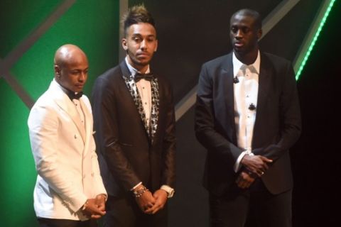 Gabonese striker Pierre-Emerick Aubameyang (C) flanked Ivorian striker Yaya Toure (R) and his Ghanaian counterpart Andre Ayew wait for verdict during the 2015 GLO-CAF African Footballer of the Year Award in Abuja, on December 7, 2016. AFP PHOTO/PIUS UTOMI EKPEI / AFP / PIUS UTOMI EKPEI        (Photo credit should read PIUS UTOMI EKPEI/AFP/Getty Images)