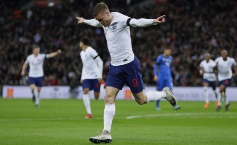 England's Jamie Vardy celebrates after scoring his side's opening goal during the international friendly soccer match between England and Italy at the Wembley Stadium in London, Tuesday, March 27, 2018. (AP Photo/Kirsty Wigglesworth)