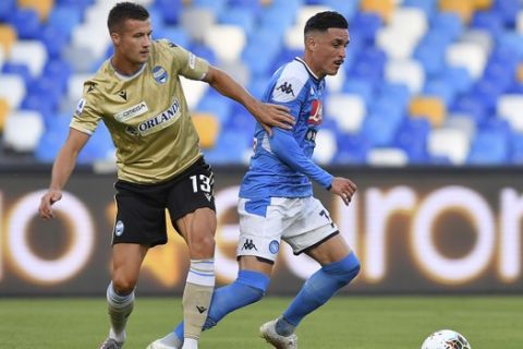Napoli's Jose Maria Callejon, right, competes for the ball with SPAL's Arkadiusz Reca during the Serie A soccer match between Napoli and SPAL, at the San Palo Stadium in Naples, Italy, Sunday, June 28, 2020. (Cafaro/LaPresse via AP)