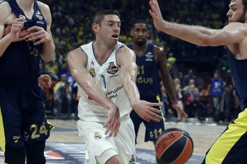 Real Madrid's Fabien Causeur passes the ball past Fenerbahce's Nicolo Melli and Jan Vesely, left, tries to score as blocks him during their Final Four Euroleague final basketball match between Real Madrid and Fenerbahce in Belgrade, Serbia, Sunday, May 20, 2018. (AP Photo/Darko Vojinovic)