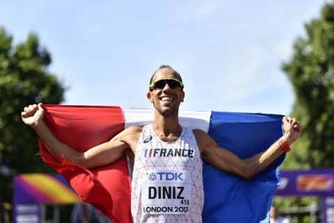 France's Yohann Diniz celebrates after crossing the line to win the gold medal in the men's 50-kilometer race walk during the World Athletics Championships in London Sunday, Aug. 13, 2017. (AP Photo/Martin Meissner)