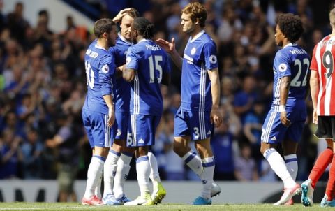 Chelsea's John Terry, second left, is embraced by his teammates, from left, Eden Hazard, Victor Moses, Marcos Alonso and Willian as his is substituted off in the 26th minute, to match his 26 shirt number as he is expected to leave the club, during the English Premier League soccer match between Chelsea and Sunderland at Stamford Bridge stadium in London, Sunday, May 21, 2017. (AP Photo/Frank Augstein)