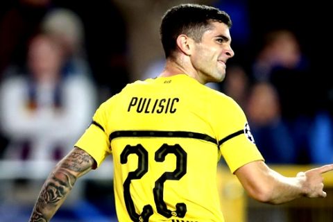 Borussia Dortmund's Christian Pulisic celebrates scoring his side's first goal during a Champions League group A soccer match between Club Brugge and Borussia Dortmund at the Jan Breydel Stadium in Bruges, Belgium, Tuesday, Sept. 18, 2018. (AP Photo/Francisco Seco)