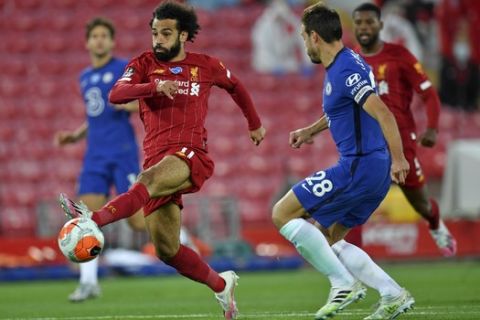 Liverpool's Mohamed Salah kicks the ball during the English Premier League soccer match between Liverpool and Chelsea at Anfield stadium in Liverpool, England, Wednesday, July 22, 2020. (Paul Ellis, Pool via AP)