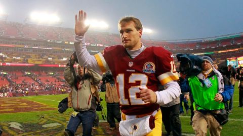 December 9, 2012; Landover, MD, USA; Washington Redskins quarterback Kirk Cousins (12) waves to fans as he leaves the field after the Redskins game against the Baltimore Ravens at FedEx Field. The Redskins won 31-28 in overtime. Mandatory Credit: Geoff Burke-USA TODAY Sports